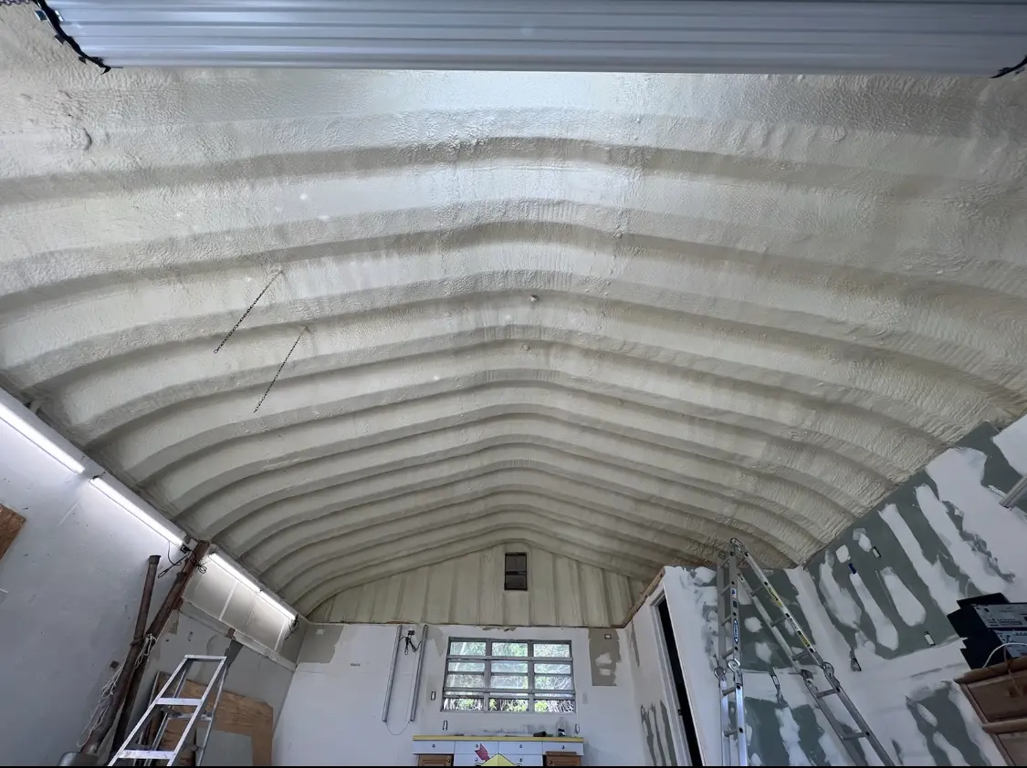 Spray polyurethane foam applied to the underside of a metal roof deck in Stow